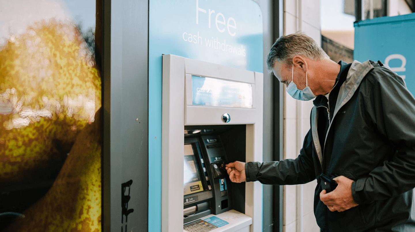 Customer withdrawing cash at a Skyline Finance ATM