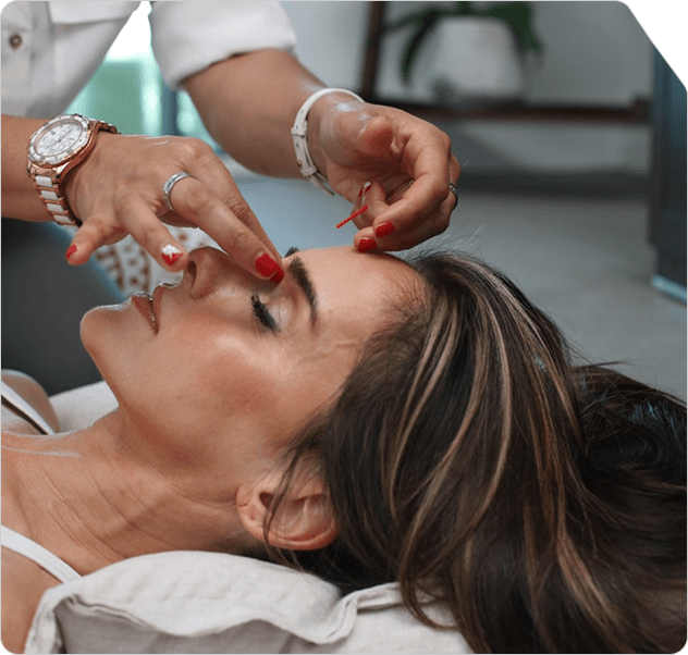 Client receiving a facial treatment at a Lumina Wellness studio